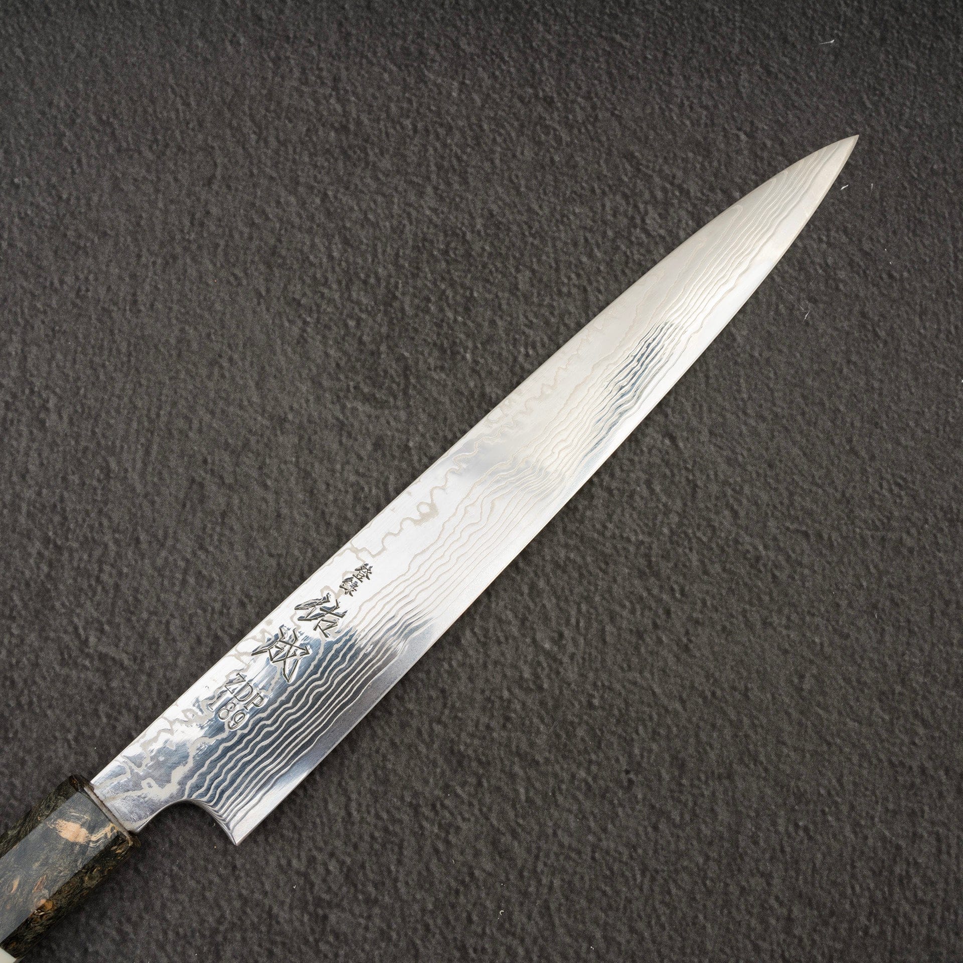 SukenariZDP189DamascusSujihiki240mmBurlHandleb.jpg Sukenari ZDP-189 Damascus Sujihiki 240mm Burl Handle with Saya, view 3